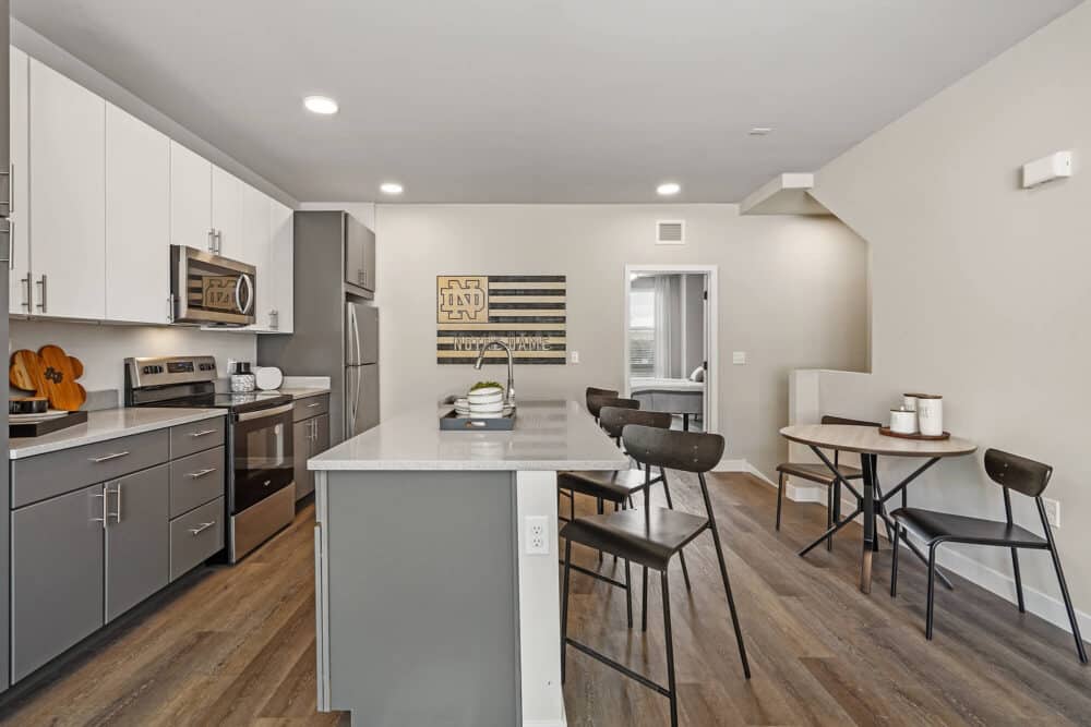 kitchen with island, new countertops, bar stools and notre dame university decoration